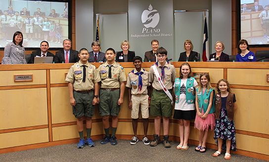Student Greeters, 4 Boy Scouts and 3 Girl Scouts, are pictured with the Board of Trustees
